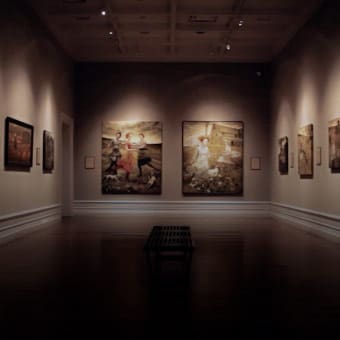 Photo of a dimly lit art exhibition room in a museum.