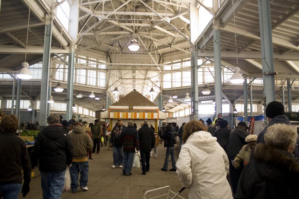 Photo of a bustling crowd inside one of the indoor markets apart of the Eastern Market.