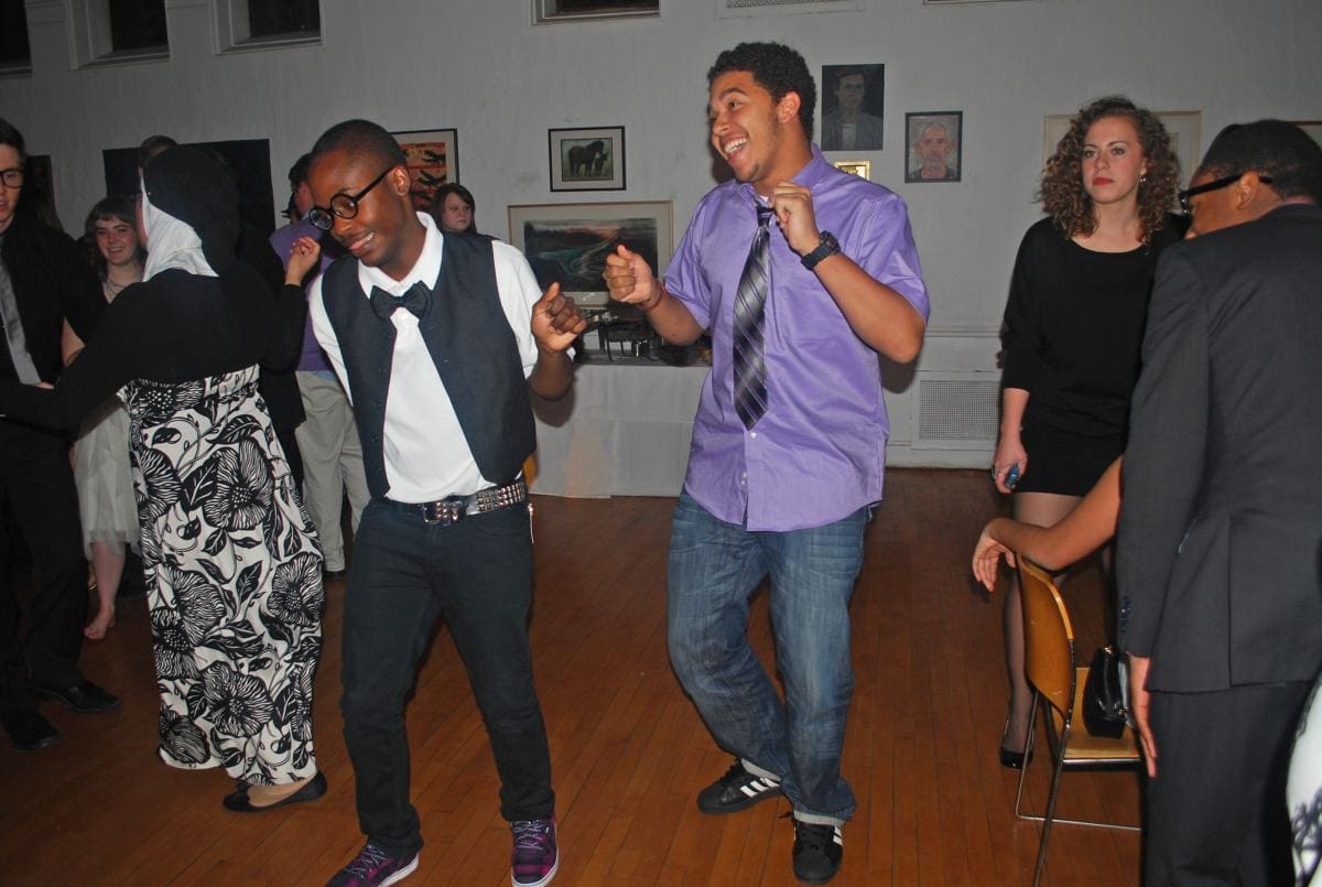 Two dapper dressed people dancing at a formal party