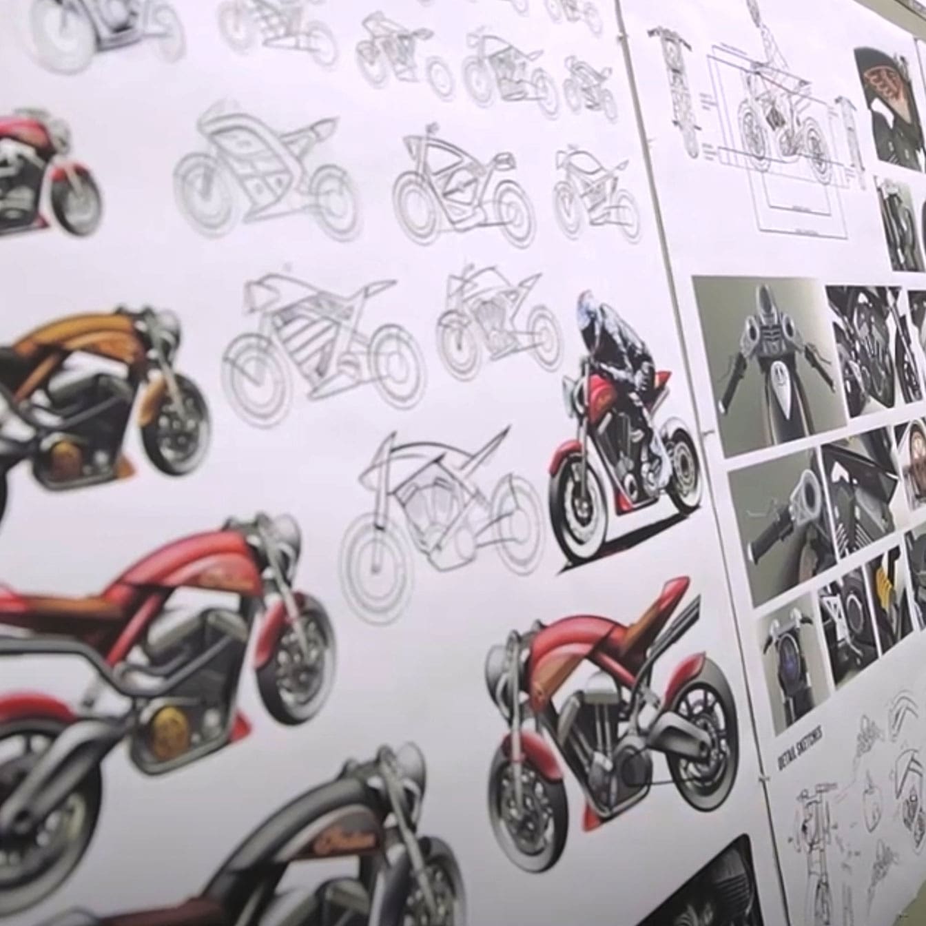 Close-up photo of a wall full of motorcycle sketches and digital renderings.