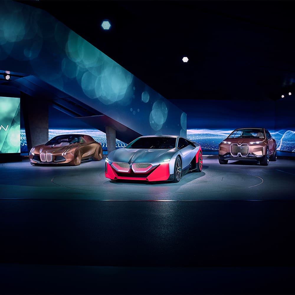 An image of futurisctic concept cars being displayed in an artistic showroom.