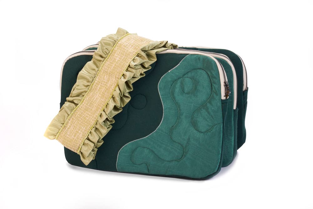 Teal and cream colored fabric accordion bag