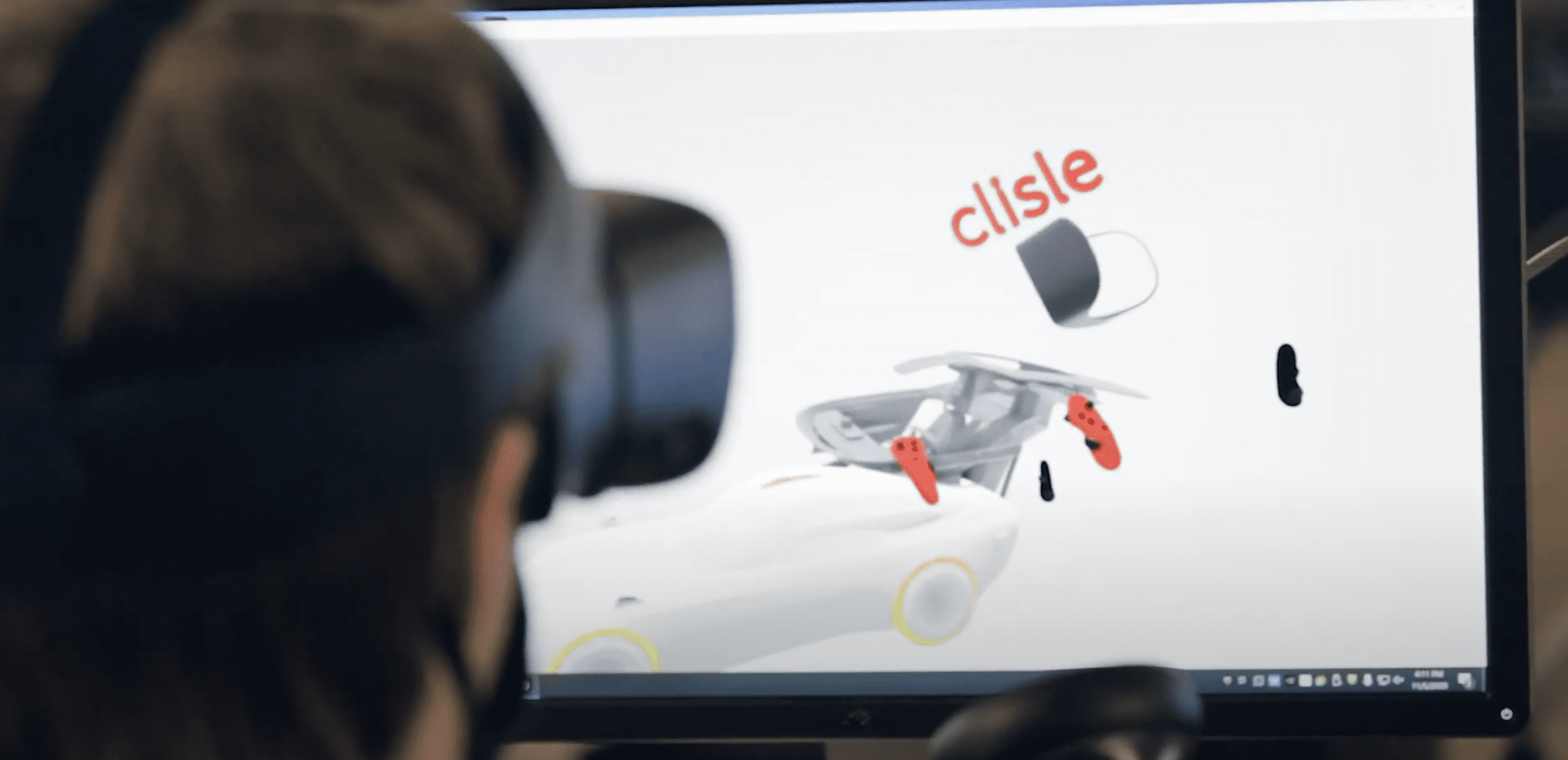 Image of a student using virtual reality headset to design a car