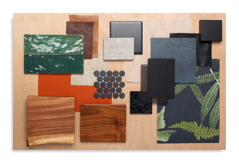 Collage of black fabric samples, wooden panels, and leaf prints on wooden background