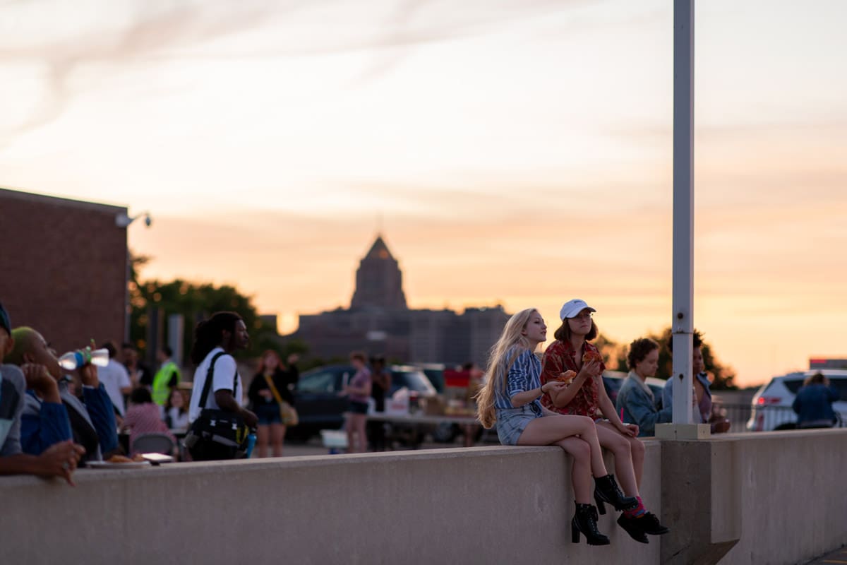 Photo of a crowd hanging out in Detroit at sunset