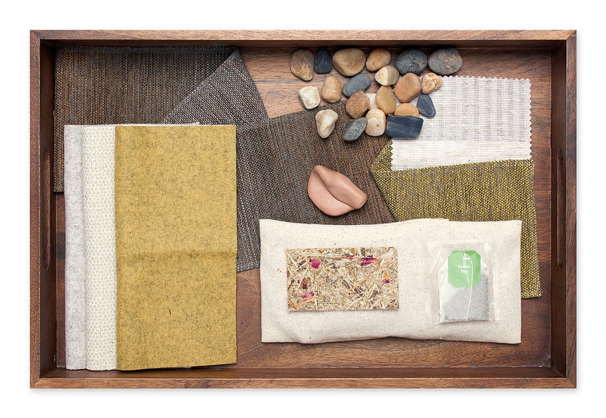 herbs, various colored fabrics and stones on a wooden tray