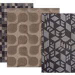 Three neutral colored geometric patterned squares of fabric