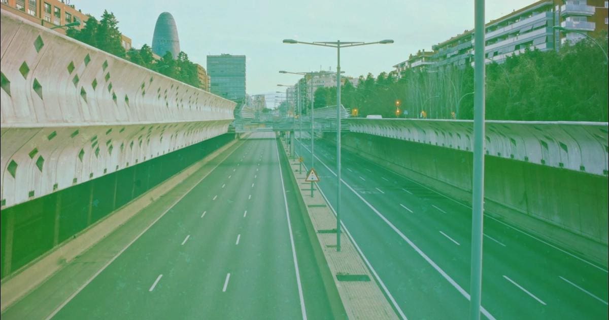 Still from a Film project depicting a long stretch of highway during midday with a film grain filter on top.